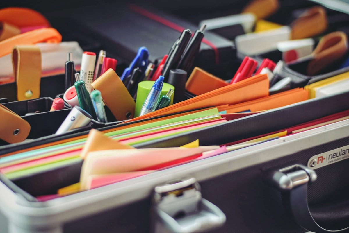 Pens, markers, folders and paper organised in a desk case